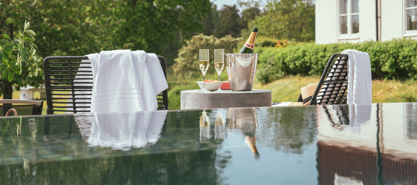 Bord med champagne och snacks vid utomhuspoolen